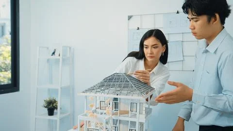 Smart engineer team focusing on checking the house model structure. Immaculate. Stock Photos
