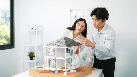 Smart engineer team focusing on checking the house model structure. Immaculate. Stock Photos