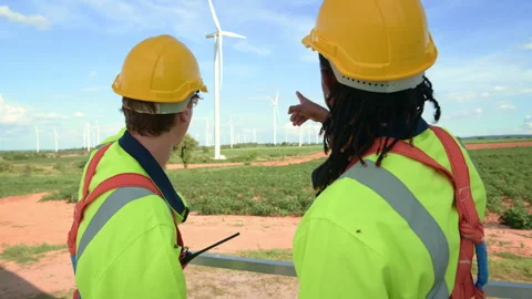 Smart engineers with protective helmet shaking hands at electrical turbines.. Stock Footage 269100438