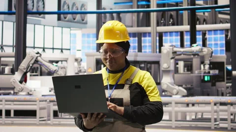 Smart factory engineer using laptop to implement automated workflows Stock Footage 307365133