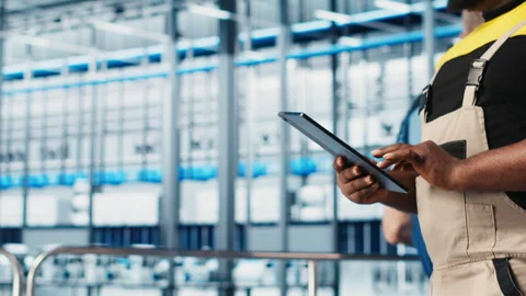 Smart factory expert using digital device app to test automated systems, closeup Stock Footage 305485964