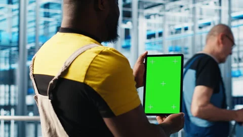 Smart factory expert using green screen tablet to test automated systems Stock Footage 305469397