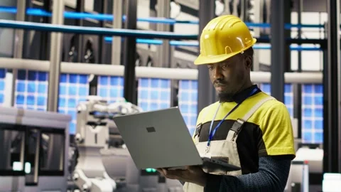Smart factory specialist, testing automated systems, monitoring production Stock Footage 308720030