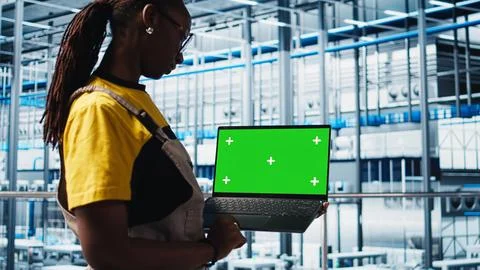 Smart factory specialist using mockup laptop to test automated systems 写真素材