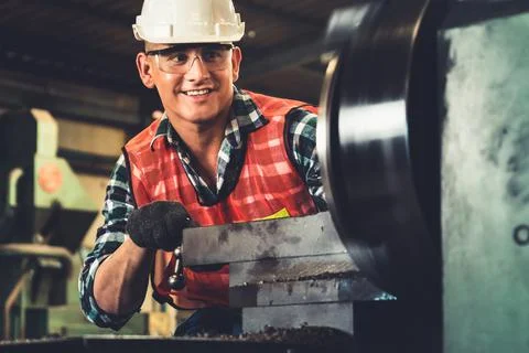 Smart factory worker or engineer do machine job in a manufacturing workshop Stock Photos