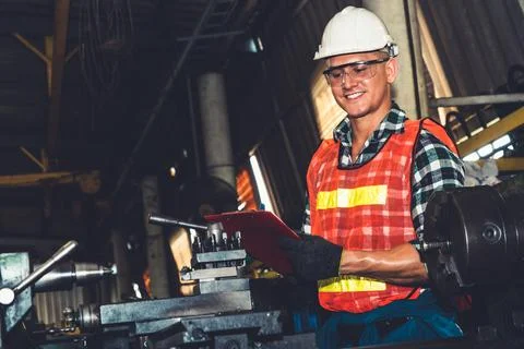 Smart factory worker or engineer do machine job in a manufacturing workshop Stock Photos