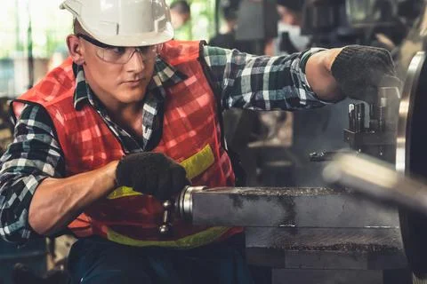 Smart factory worker or engineer do machine job in a manufacturing workshop Stock Photos