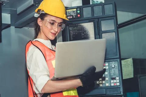 Smart factory worker or engineer do machine job in the manufacturing workshop Stock Photos