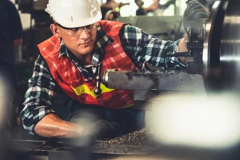Smart factory worker or engineer do machine job in a manufacturing workshop Fotos Stock