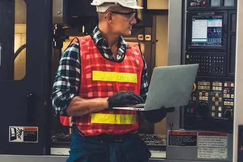 Smart factory worker or engineer do machine job in a manufacturing workshop Stock Photos