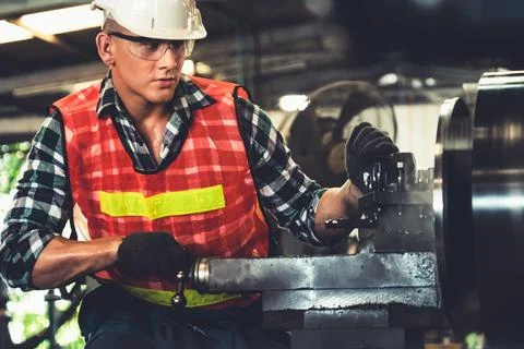 Smart factory worker or engineer do machine job in a manufacturing workshop Stock Photos