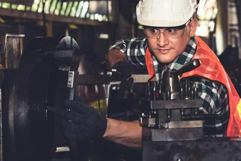 Smart factory worker or engineer do machine job in a manufacturing workshop Stock Photos