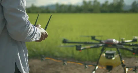 Smart farmer using drone controller or drone transmitter a remote control f.. Stock Footage 325804955
