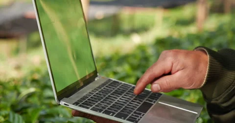 Smart farmer using laptop in eco green farm sustainable quality control. Stock Footage 245329669