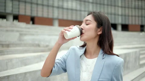 Smart female drinking coffee cup and going with tablet to office in the morning. Stock Footage 169903400