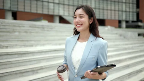 Smart female going with tablet and coffee cup to office in the morning. Stock Footage 169903666