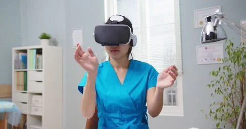 Smart female medical student using 3D glasses to do surgery in virtual reality Stock Footage 147073672