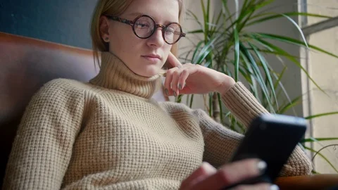 Smart geek girl using mobile phone installing app Strolling and publishing post Stock Footage 103286648