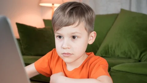 Smart genious boy using a computer. Child studying and learning from computer Video stock 128945491