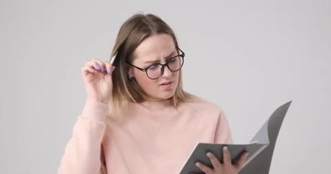 Smart girl with glasses solves a difficult problem Stock Footage 142020737