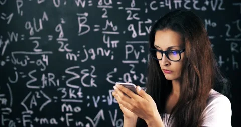 Smart girl student over high school math and science formulas on blackboard Stock Footage