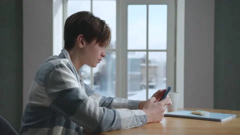 Smart Guy Teenager Using Smartphone in Home Room at Side View Stock Footage 166374194