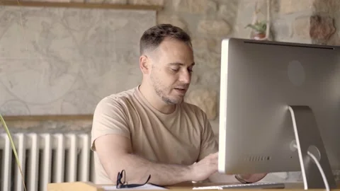 Smart handsome man making a webcam calling by computer with the team and maki Stock Footage 221941923