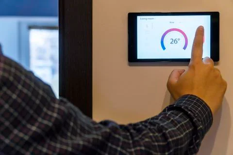 Smart home climate control device on a wall Stock Photos