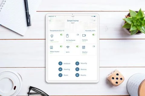 Smart home control app on tablet display. Home desk, top view, flat lay. Mode Stock Photos