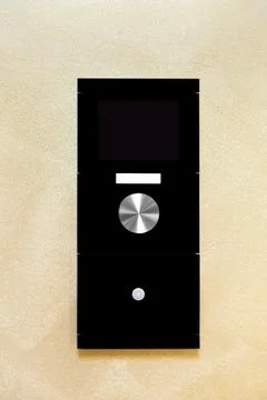 Smart home control controller with a screen and buttons to control the light. Stock Photos