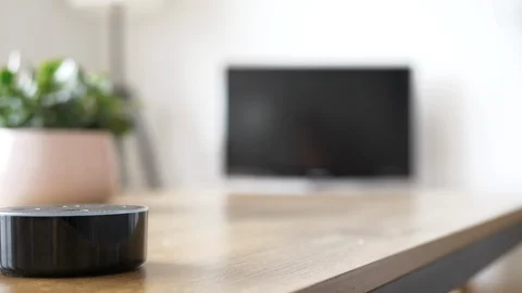Smart Home Device Turns On The TV While Woman Puts Her Feet Up At Home Video stock 126906984