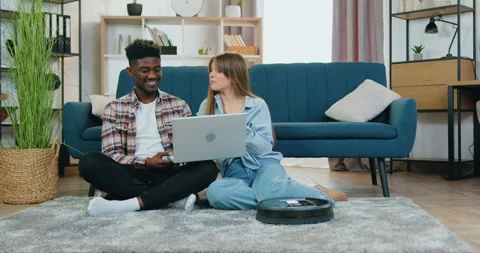 Smart home function concept where attractive satisfied multiracial guy and girl Stock Footage 154899279