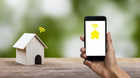 Smart home future technology concept. A man hand using smartphone control eve Stock Photos