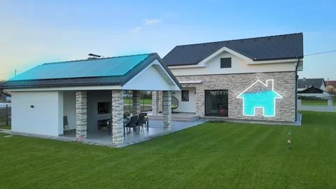Smart home with rooftop solar panel and graphic logo of renewable energy Stock Photos
