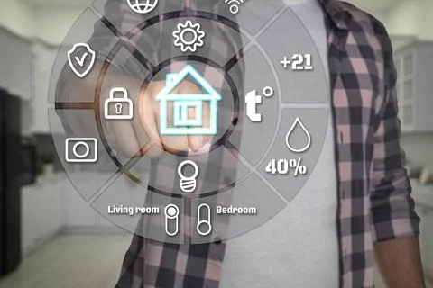 Smart home system. Man using digital interface in room, closeup Stock Photos