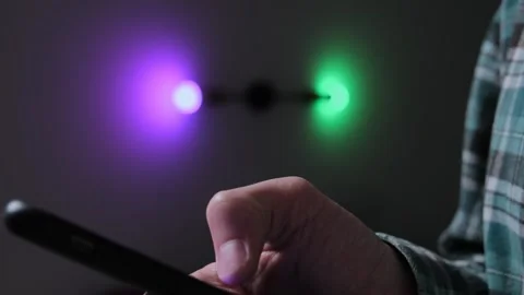 Smart home systems. Man using smartphone to adjust smart lighting, choosing ligh Stock Footage 296901124