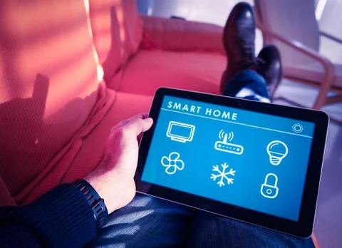 Smart home technology interface on tablet app screen, person holding device Stock Photos