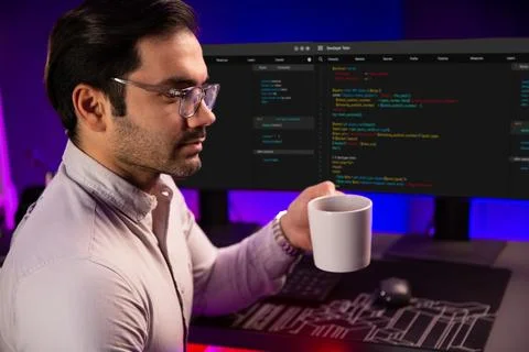 Smart IT developer drinking coffee cup while working code on pc screen. Surmise. Stock Photos