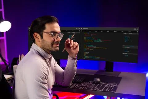 Smart IT developer holding pencil with software development coding. Surmise. Stock Photos