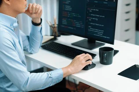 Smart IT developer looking at coding program application on computer. Infobahn. Stock Photos