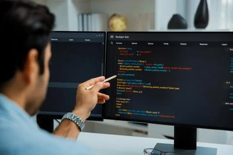 Smart IT developer pointing data software development lines on pc. Surmise. 스톡 사진