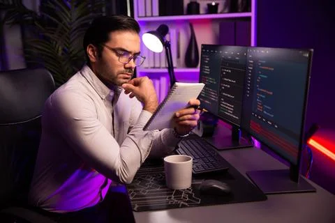 Smart IT working software development coding on pc with reading note. Surmise. 스톡 사진