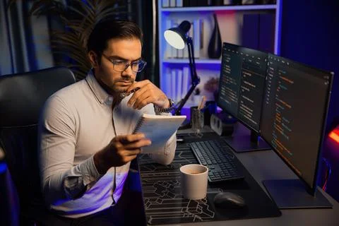 Smart IT working software development coding on pc with reading note. Surmise. 스톡 사진