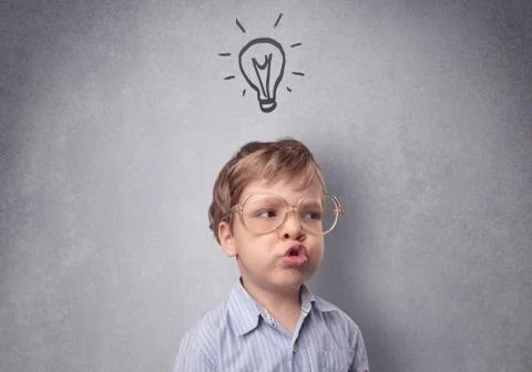 Smart kid in front of a drawn up grey wall Stock-Fotos