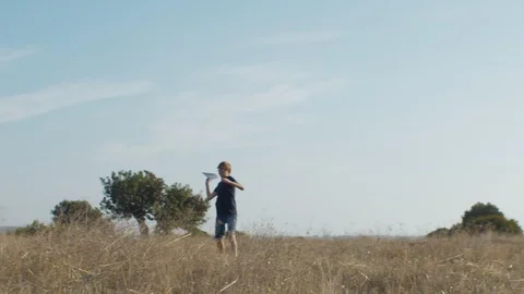 Smart kid in glasses testing handmade planes Stock Footage 129423271