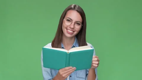 Smart lady hold notebook paper page read isolated green color background Stock Footage 166044958