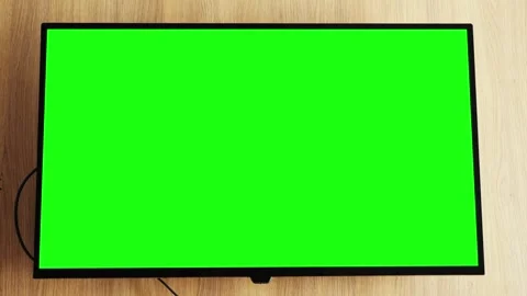 Smart LCD TV screen with green screen on wooden wall background in the living Stock Footage 323442518