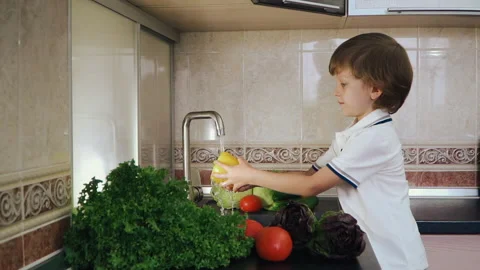 Smart Little Boy Preparing Salad, Washes Bell Pepper, Other Vegetables Video stock 135540935