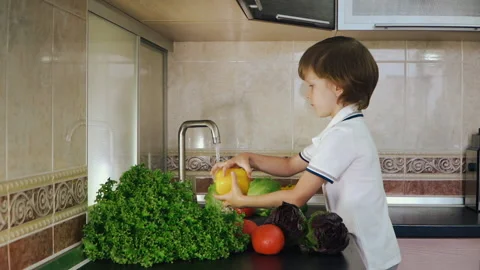 Smart Little Boy Preparing Salad, Washes Bell Pepper, Other Vegetables Stock Footage 135540994