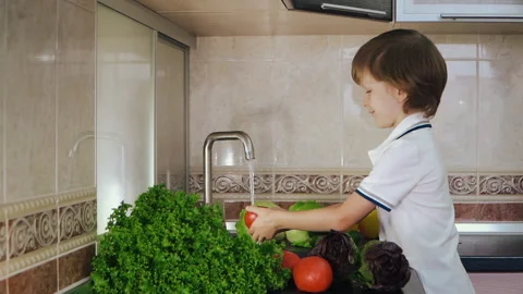 Smart Little Boy Preparing Salad, Washes Bell Pepper, Other Vegetables Video stock 135541666